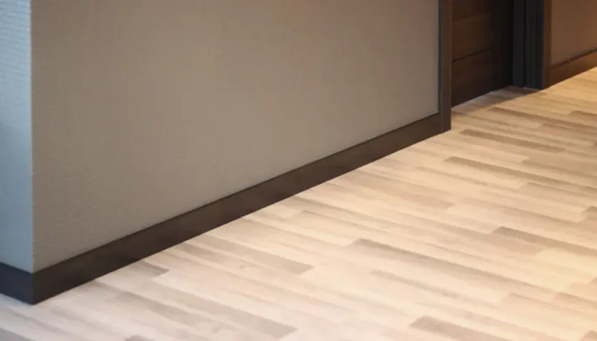Jasne, oto opis:

Nowoczesne wnętrze z jasną podłogą i ciemnymi cokołami, które podkreślają elegancję pomieszczenia.